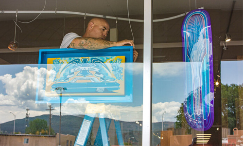 Artist behind a window fixing public art installations